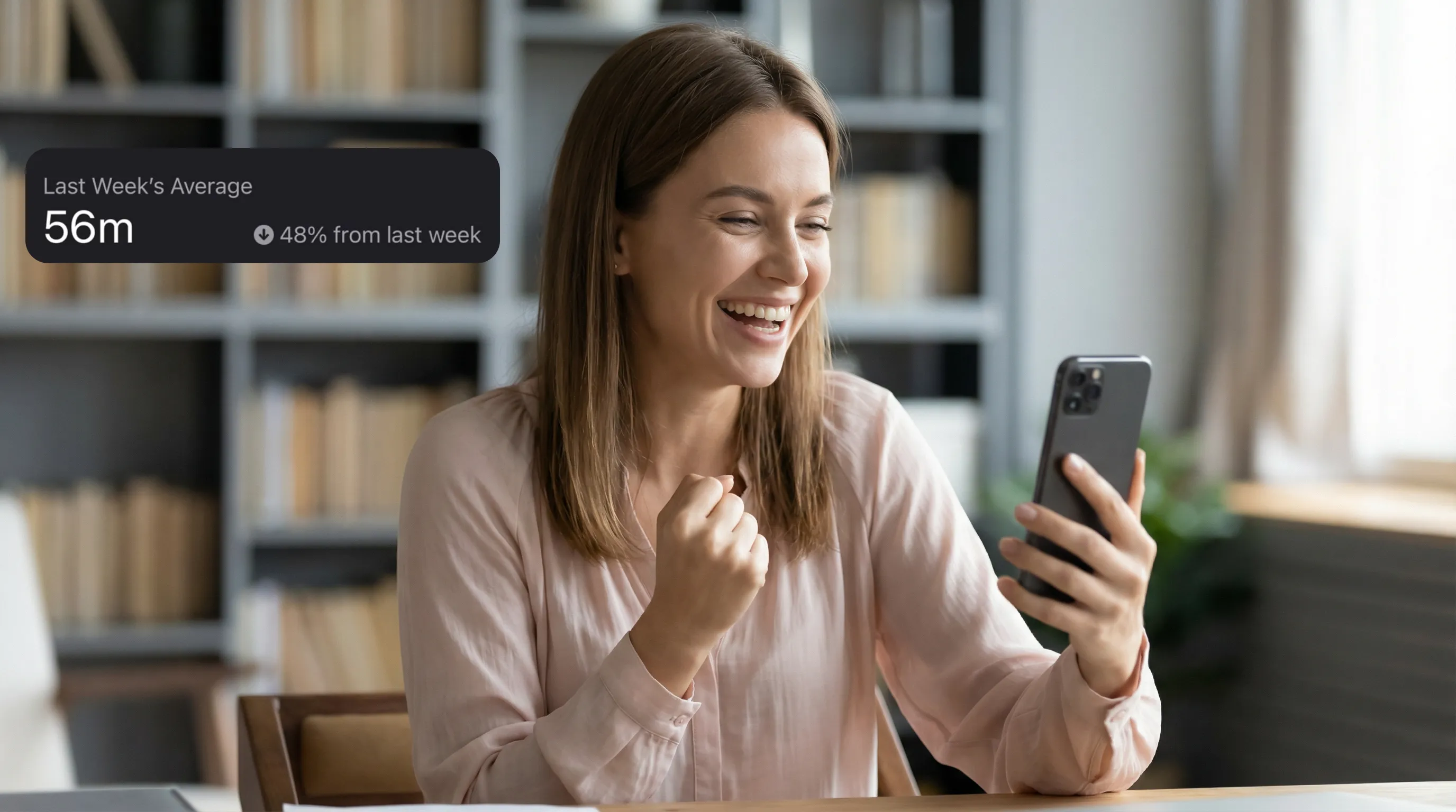 Happy woman viewing 48 percent screen time reduction success on smartphone showing healthy digital balance